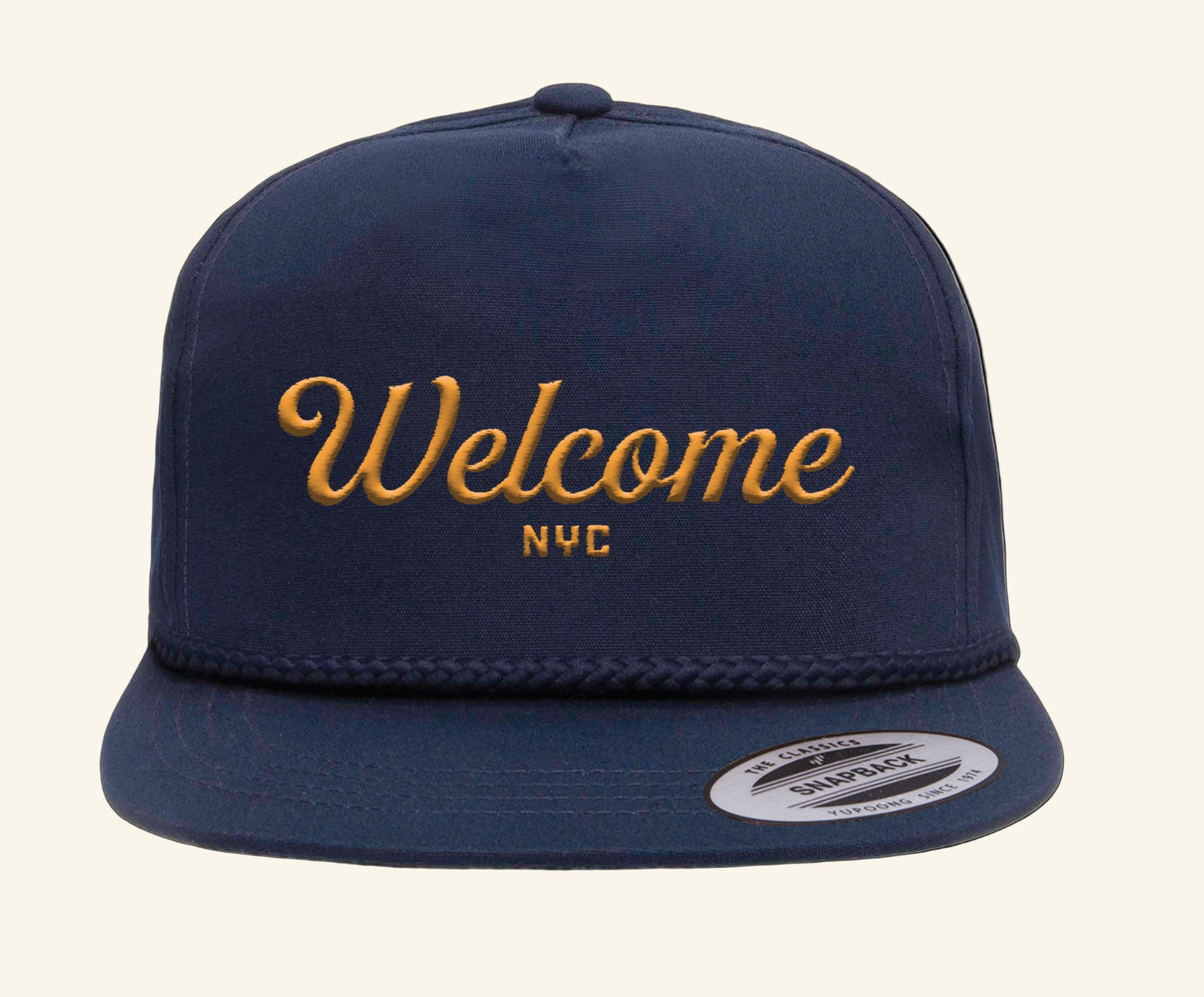 Navy blue cap with 'Welcome NYC' in gold on a black background